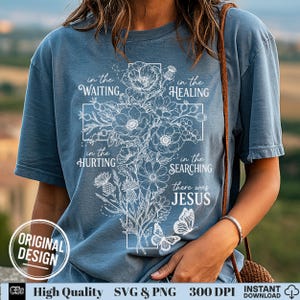 Woman wearing a blue t-shirt with a white line-art floral cross and there was Jesus quote.
