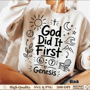 May include: A beige crewneck sweatshirt featuring a black graphic print with the text God Did It First and Genesis. The design includes illustrations of a sun, a cross, a crescent moon, stars, a globe, a wave, mountains, and a chair.