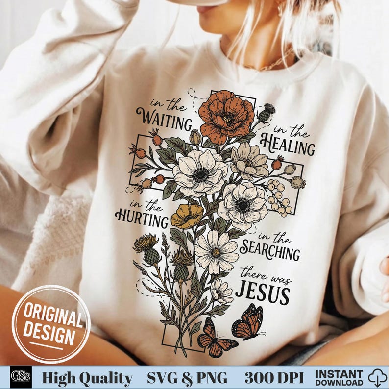 Close up of a woman in a cream sweatshirt featuring a retro floral cross Christian graphic.