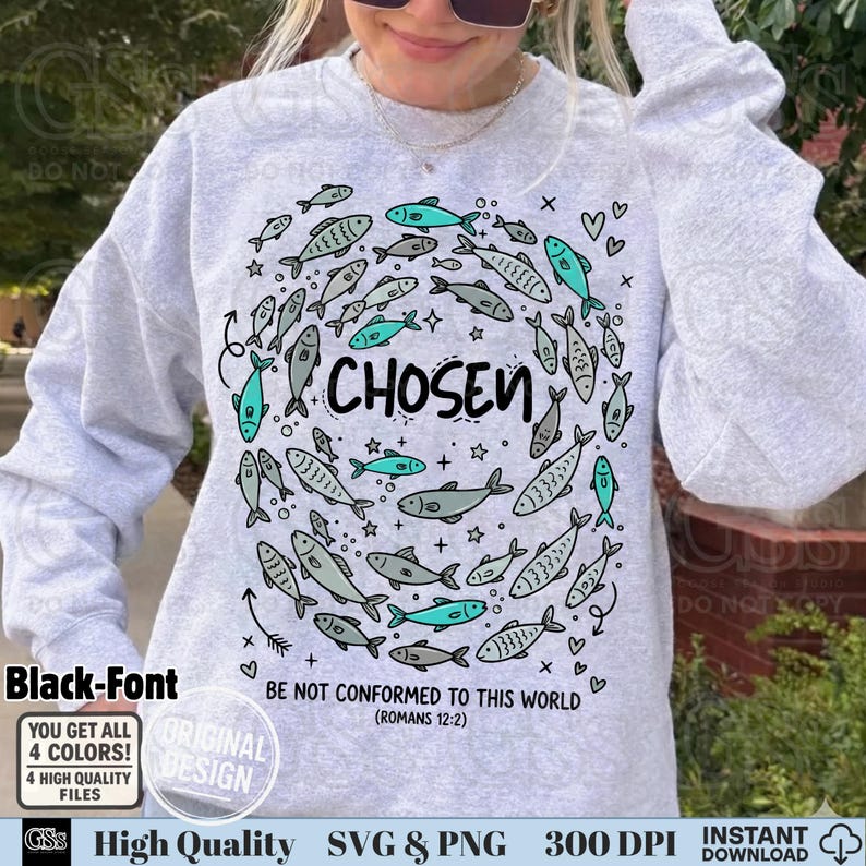 May include: A light gray sweatshirt with a fish design in a circle around the word "CHOSEN". The design includes teal and gray fish, hearts, and stars. The text "BE NOT CONFORMED TO THIS WORLD (ROMANS 12:2)" is also printed on the sweatshirt.