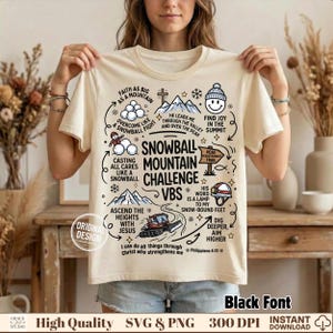 May include: A cream-colored t-shirt featuring a graphic design with the text SNOWBALL MOUNTAIN CHALLENGE VBS. The print includes illustrations of mountains, snowballs, a snowcat vehicle, a beanie, and various inspirational phrases.