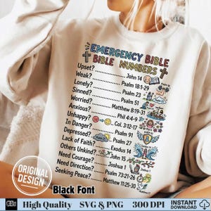 May include: A cream-colored sweatshirt featuring the text "EMERGENCY BIBLE NUMBERS" in colorful lettering. Below, a list of emotional states with corresponding Bible verses is displayed. The design includes small illustrations and the words "ORIGINAL DESIGN" and "Black Font".