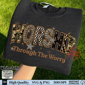 May include: Black sweatshirt with the word "WORSHIP" in a mix of camouflage, leopard print, and checkered patterns. The phrase "Through The Worry" is embroidered below. The design includes star accents.