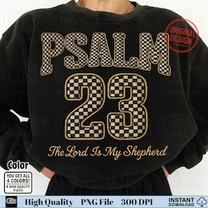May include: Black sweatshirt with the text "PSALM 23" in a checkered pattern. The phrase "The Lord Is My Shepherd" is written below the numbers. The design includes a "Original Design" stamp.