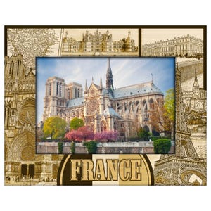 May include: A rectangular photo frame featuring a central image of Notre Dame Cathedral in Paris, France. The frame includes sepia-toned illustrations of French landmarks and a map. The word "FRANCE" is prominently displayed.