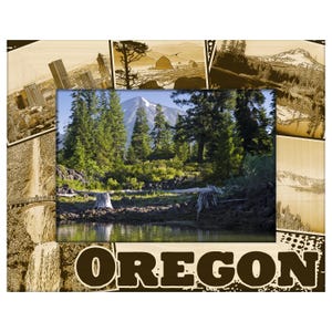 May include: A wooden picture frame with a central image of a forest and mountain scene. The frame is decorated with sepia-toned images of Oregon landmarks and the word "OREGON" in large letters.