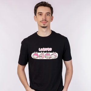 May include: Black crew neck t-shirt with a graphic of four cartoon characters with pink details and the word "LABUBU" above. The design is centered on the front of the shirt.