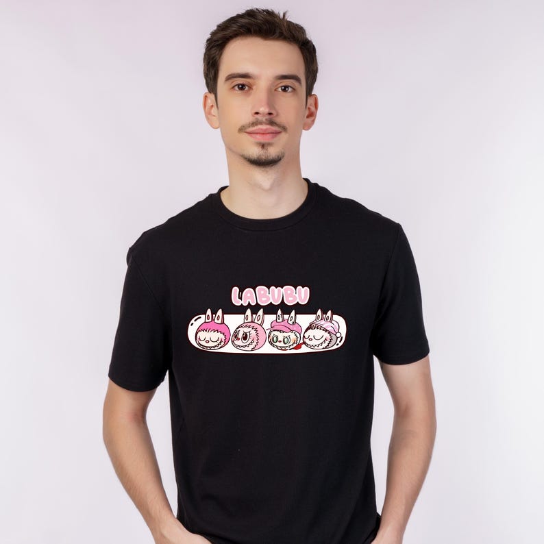May include: Black crew neck t-shirt with a graphic of four cartoon characters with pink details and the word "LABUBU" above. The design is centered on the front of the shirt.