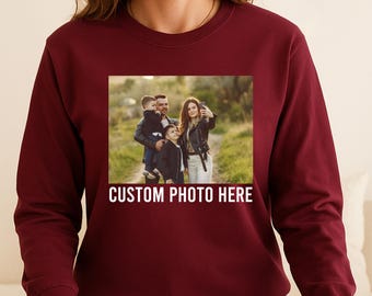 May include: A maroon sweatshirt with a rectangular image of a family taking a selfie. The image is framed by the text "CUSTOM PHOTO HERE" in white. The sweatshirt is a solid color.