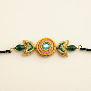 Handcrafted Circle Motif Rakhi – Green Thread with Leaf Accents