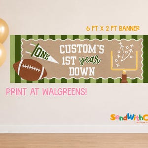 May include: A rectangular banner measuring 6 ft by 2 ft with a green and white striped border. The center features a brown football, a white pennant with the word ONE, and a yellow goalpost. Text reads: CUSTOM'S 1ST year DOWN.