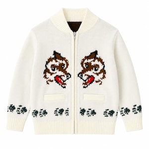 May include: Cream-coloured zip-up cardigan sweater with a high collar and two front pockets. The sweater features a repeating pattern of green leaf-like shapes along the bottom and sleeves. Two brown and red cartoon tiger faces are on the front.