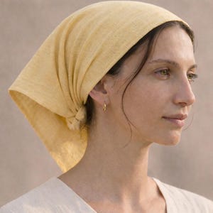 May include: A handmade wooden sign with the text "Welcome" in a whimsical font. The sign is painted white with a distressed finish, and features a decorative floral design in shades of pink and green. It measures approximately 12 inches wide and 6 inches tall.