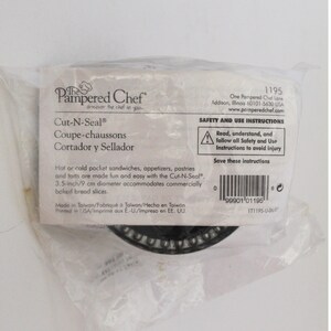 May include: A Pampered Chef Cut-N-Seal kitchen tool packaged in a clear plastic bag. The white label features black text, a barcode, and safety instructions. The text specifies a 3.5-inch diameter for pocket sandwiches, appetizers, and pastries.