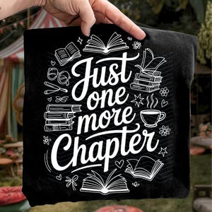 May include: Black square pillow with the text "Just one more chapter" in white script. The design includes illustrations of books, glasses, flowers, and a coffee cup, perfect for book lovers.