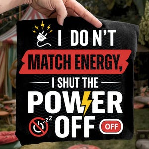 May include: Black pillow with the text "I DON'T MATCH ENERGY, I SHUT THE POWER OFF" in white. The design includes a red banner, a lightning bolt, and a plug icon. The word "OFF" is in a red circle.