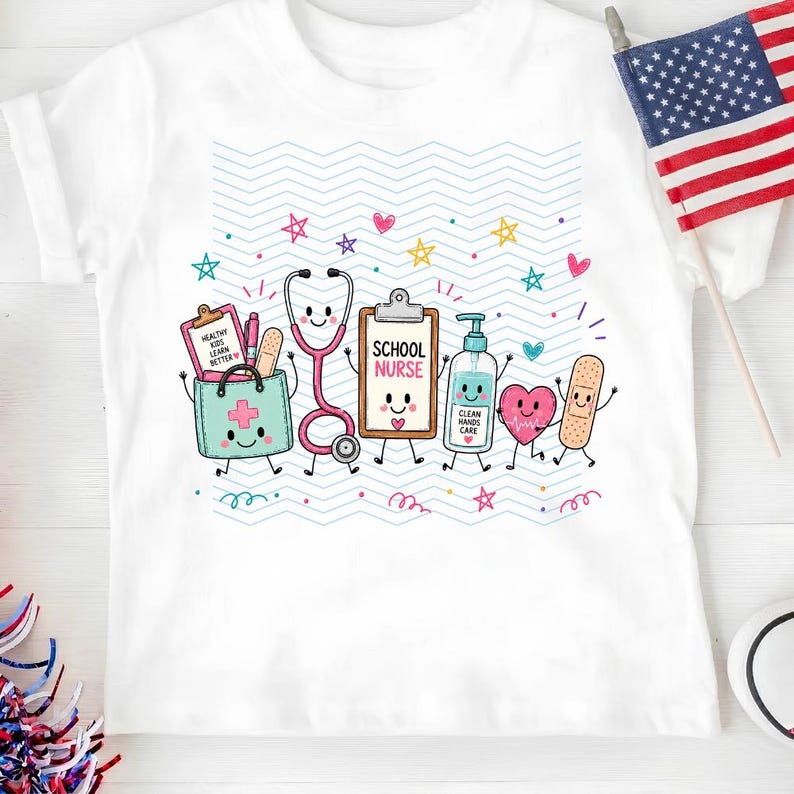 May include: A white t-shirt featuring a colorful graphic of anthropomorphic school nurse supplies including a stethoscope, clipboard labeled SCHOOL NURSE, hand sanitizer, heart, and bandage, set against a background of light blue wavy lines.