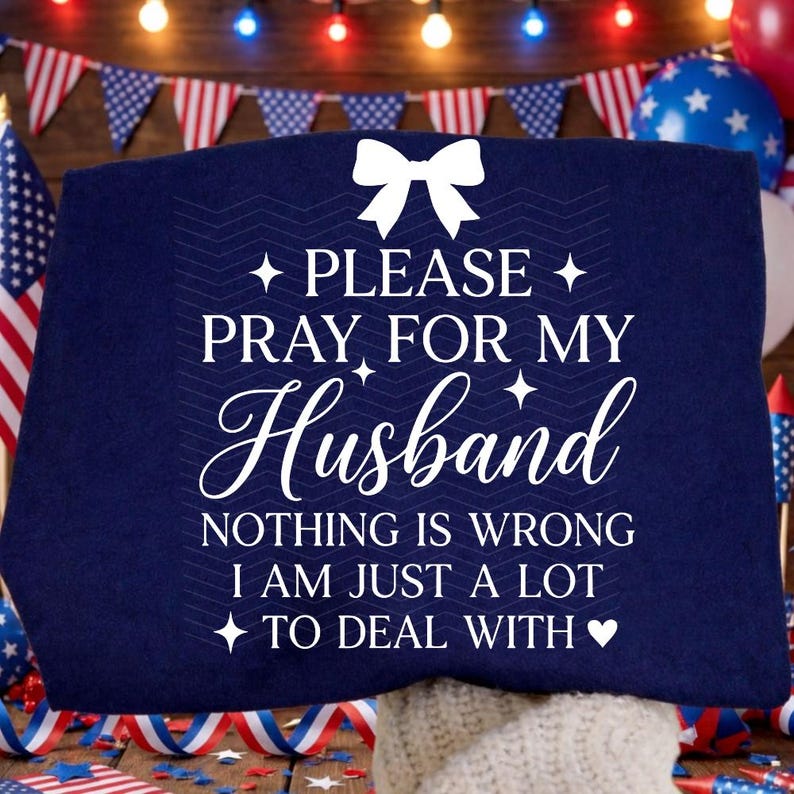 May include: A navy blue cushion with the text "PLEASE PRAY FOR MY Husband NOTHING IS WRONG I AM JUST A LOT TO DEAL WITH." The cushion has a white bow and star accents. Patriotic theme with flags and balloons.