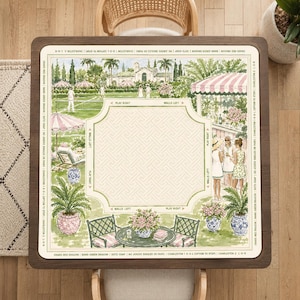 May include: A square mahjong mat featuring a watercolour illustration of a tennis court and garden party scene. The centre has a light beige geometric pattern with directional text. The border includes the text: CRACKS-RED DRAGON BAMS-GREEN DRAGON DOTS-SOAP NO JOKERS SINGLES OR PAIRS CHARLESTON 1 R-O-L (OPTION TO STOP) CHARLESTON 2 L-O-R.