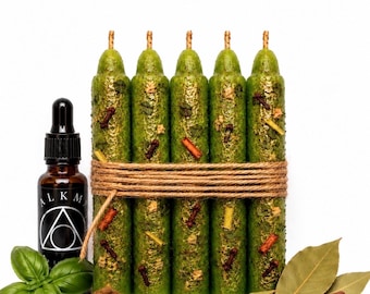 May include: Five green textured taper candles bound together with twine, accompanied by a small dropper bottle labeled ALKEMIA, a wooden bowl of brown powder, fresh green basil leaves, dried bay leaves, cinnamon sticks, and whole cloves.