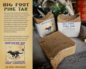 May include: Two bars of brown soap with a label that reads "Big Foot Pine Tar" and "Northern Bay Soap Company". The soap is handcrafted and hand-cut, making each bar unique.