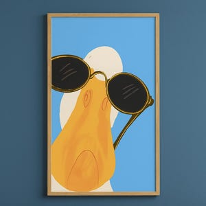 May include: A framed art print featuring a cartoon duck wearing sunglasses. The duck has a yellow beak and is set against a blue background. The sunglasses are black with gold frames, adding a touch of style.