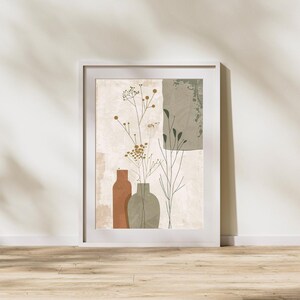 May include: A framed art print featuring an abstract botanical design. The artwork showcases three vases in shades of brown and green, with delicate floral elements. The background has neutral tones with textured elements, all within a white frame.