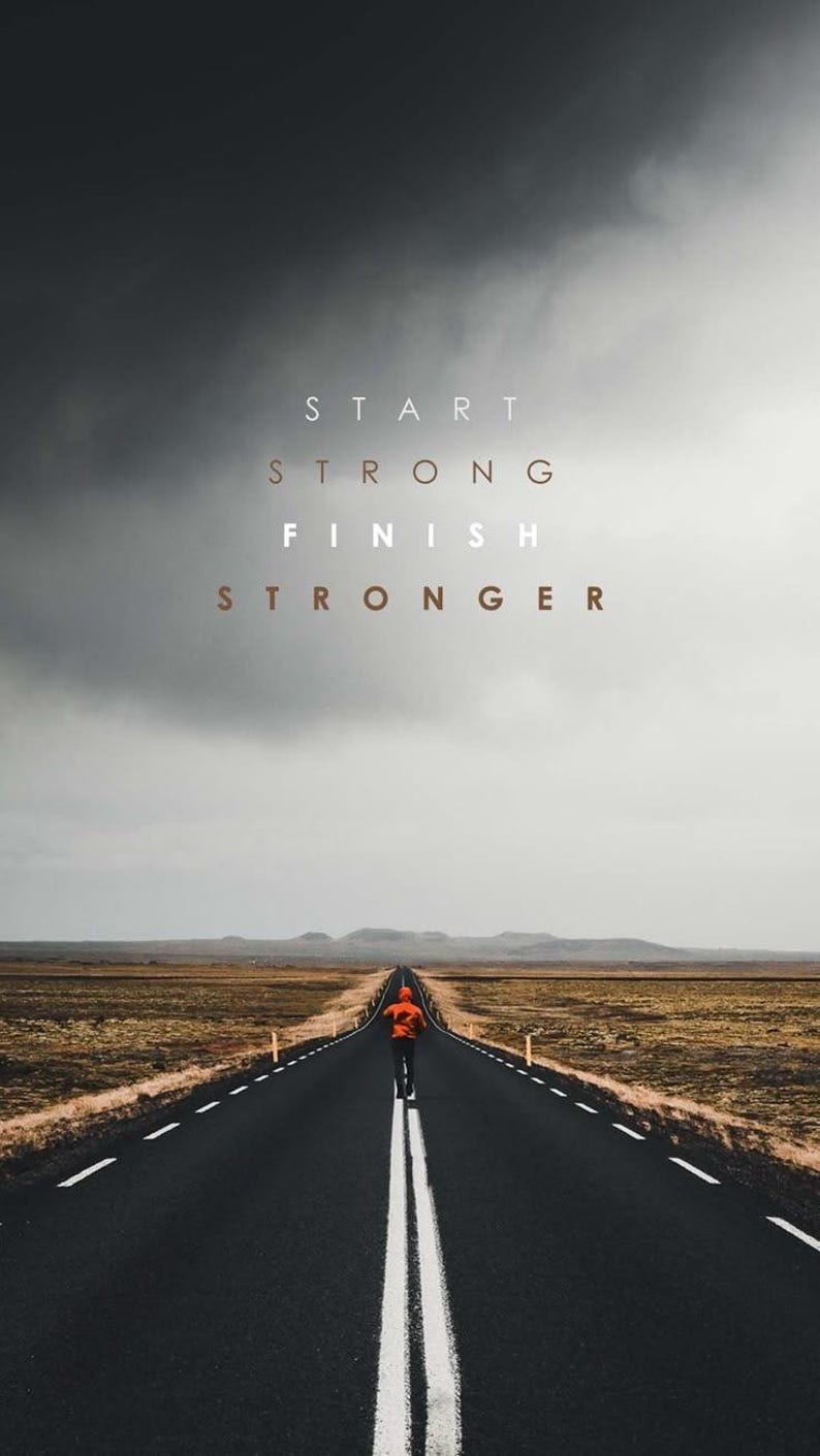 K&ouml;nnte beinhalten: Eine Person geht auf einer langen, geraden Stra&szlig;e unter einem dunklen Himmel. Der Text "START STRONG FINISH STRONGER" steht oben. Die Person tr&auml;gt eine orangefarbene Jacke.