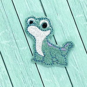 May include: A blue and white cartoon character with a sparkly finish. The character is a small, round creature with large eyes and a long, thin tail.