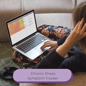 May include: A laptop displaying a symptom tracker, with a color-coded grid. The text "Chronic Illness Symptom Tracker" is displayed on a purple banner. The person is wearing a floral patterned top and black shoes are visible.