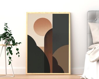 Puede incluir: Impresión artística abstracta en un marco dorado. La obra presenta un sol y formas de montaña en tonos marrones, negros y beige. El arte enmarcado se exhibe sobre un suelo de madera clara, con una planta y una cama en el fondo.