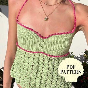 May include: A light green crochet halter top featuring a sweetheart neckline with bright pink trim and a textured lace-style bottom section. A white shell-shaped graphic overlay in the bottom right corner contains the black text PDF PATTERN.
