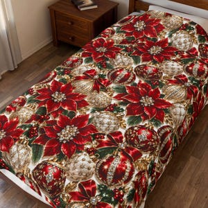 May include: A bedspread featuring a festive pattern of vibrant red poinsettia flowers, shimmering gold and red Christmas ornaments, green pine needles, and small red berries. The design is repeated across the entire surface of the fabric.