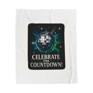 May include: A white blanket with a black square design featuring a disco ball and the text "CELEBRATE THE COUNTDOWN!". The disco ball is silver, blue, and green, with starbursts in the background.
