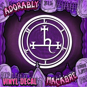 May include: A purple and white vinyl decal with the text "ADORABLY" and "MACABRE". The decal features a white circular design with a cross and the letters "H", "L", and "I". The words "VINYL DECAL" are also visible.