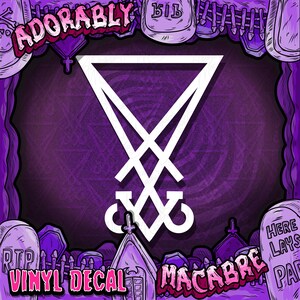 May include: A white vinyl decal featuring the symbol of Lucifer, set against a purple background with a graveyard theme. The words "Adorably," "Vinyl Decal," and "Macabre" are written in a stylized font.
