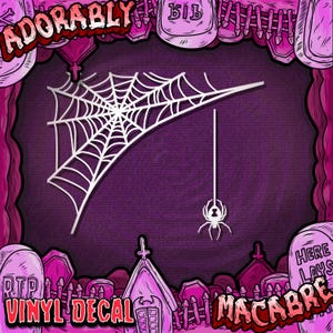 May include: White vinyl decal featuring a spider web and a hanging spider against a purple background. The words "Adorably Macabre" and "Vinyl Decal" are displayed in a spooky font, with a graveyard theme.