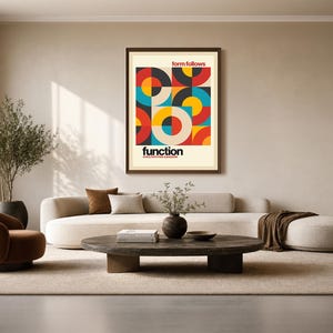 May include: A rectangular wall art print in a dark frame featuring a geometric pattern of circles and semi-circles in red, yellow, blue, and black. The text "form follows" appears at the top, and "function" is printed in bold black letters below.
