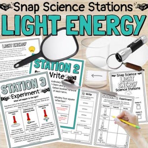 Pode incluir: Um conjunto de estações de aprendizagem de ciências com o título "Snap Science Stations LIGHT ENERGY". A imagem inclui uma lupa, uma lanterna e folhas de trabalho para experimentos. Uma mão segura um lápis amarelo.