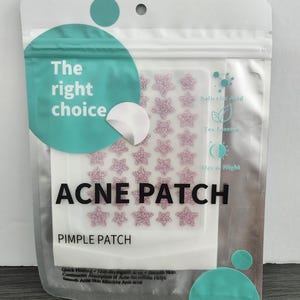 May include: A clear plastic package containing acne patches. The package has a teal circle with the words "The right choice." The patches are star-shaped and pink. The text "ACNE PATCH" and "PIMPLE PATCH" are also visible.