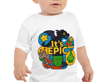 May include: A white baby t-shirt with a vibrant graphic that reads "It's EPIC". The design includes a black dragon, a yellow star, a castle, a green monster, and other cartoon elements. The shirt is worn with blue jeans.