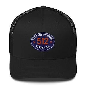 May include: Black trucker hat with a mesh back and a curved brim. The front features an embroidered patch with the text "Keep Austin Weird" and "512 Texas USA" in a circular design. A stylish accessory.