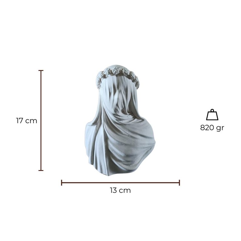 May include: A gray sculpture of a veiled bust, 17 cm tall and 13 cm wide, adorned with a floral crown. The sculpture weighs 820 grams. The draped fabric obscures the face, creating a mysterious and elegant aesthetic.