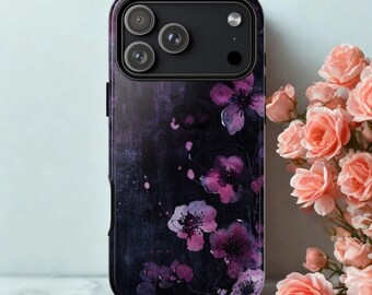 May include: A smartphone case with a dark background and a floral design. The case features a pattern of purple flowers with a textured, almost watercolor-like effect. The phone's camera lenses are visible at the top.