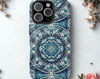 May include: A phone case with a detailed blue and white mandala design. The case features a central floral pattern surrounded by intricate geometric shapes. The color palette includes shades of blue and white, creating a visually appealing aesthetic.