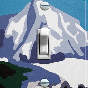 May include: A white light switch with a blue and white mountain scene on the cover. The switch is labelled "ON".