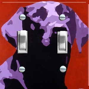 May include: A light switch cover with a purple and black silhouette of a dog's head. The switch cover has two white toggle switches labeled "ON".