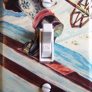 May include: A light switch cover with a vintage illustration of a skier in Norway. The cover features the text "NORWAY THE HOME OF SKI-ING".