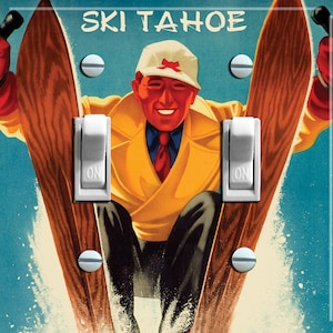 May include: A light switch cover with a retro illustration of a skier and the text "SKI TAHOE". The skier is wearing a yellow coat and a hat with a red bow. The switch is in the "ON" position. The background is a light blue.