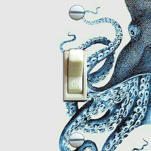 May include: A light switch cover with a blue and white illustration of an octopus with the word "ON" printed on the switch.
